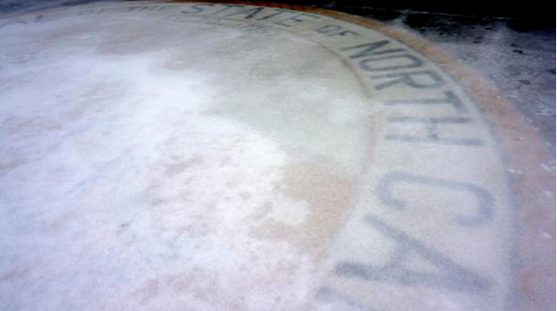 The Great Seal of North Carolina in front of the Legislative Building covered in ice.  From WRAL news.